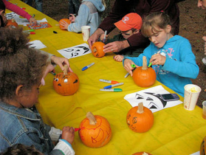 Children decorating pumpkins