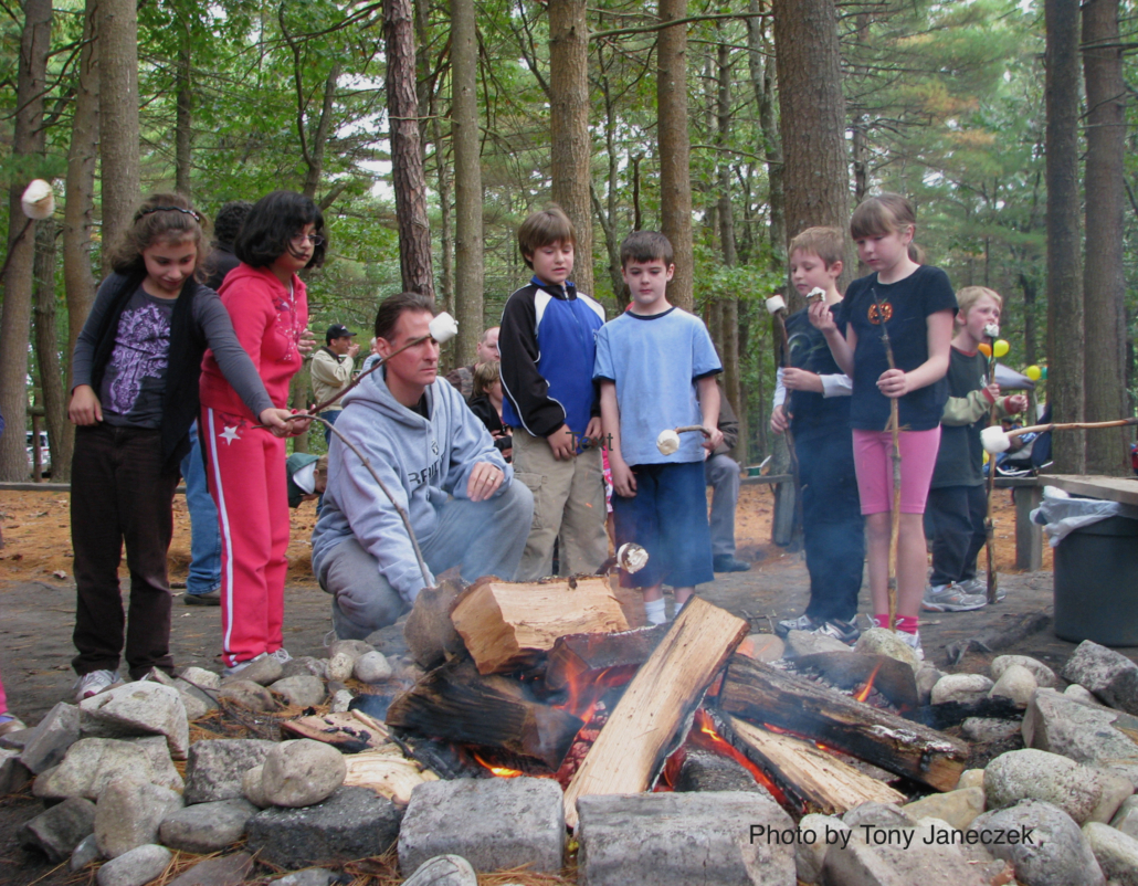 A firepit surrounded by children